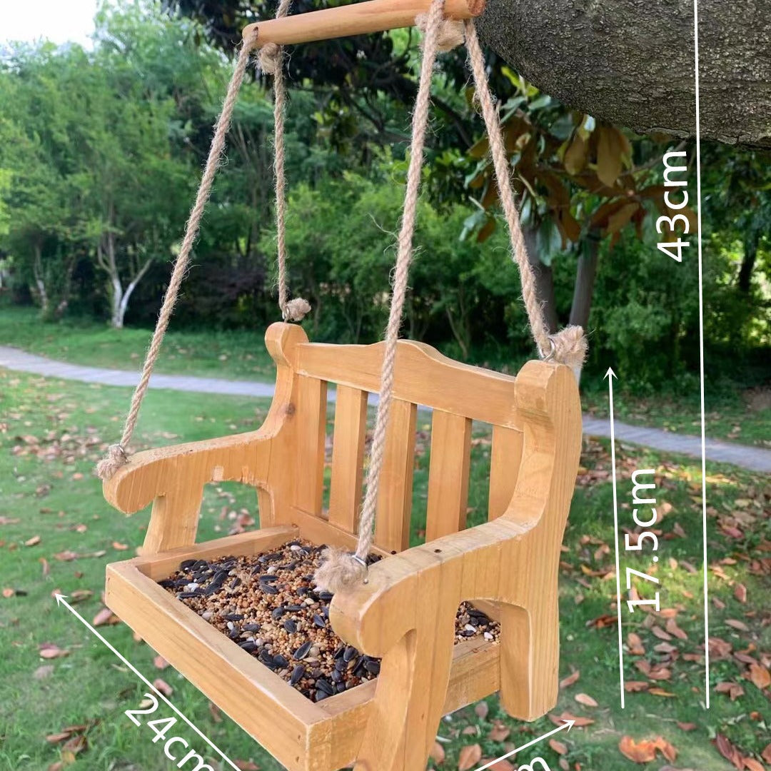 Natural wood bench bird feeder hanging from a branch with size lines of 24 cm, 17.5 cm and 43 cm