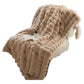 Corner of a ruched plush throw blanket showing the rows of soft fabric bubbles