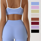 Two tone womens activewear set on a studio model with thin spaghetti straps crossing the back