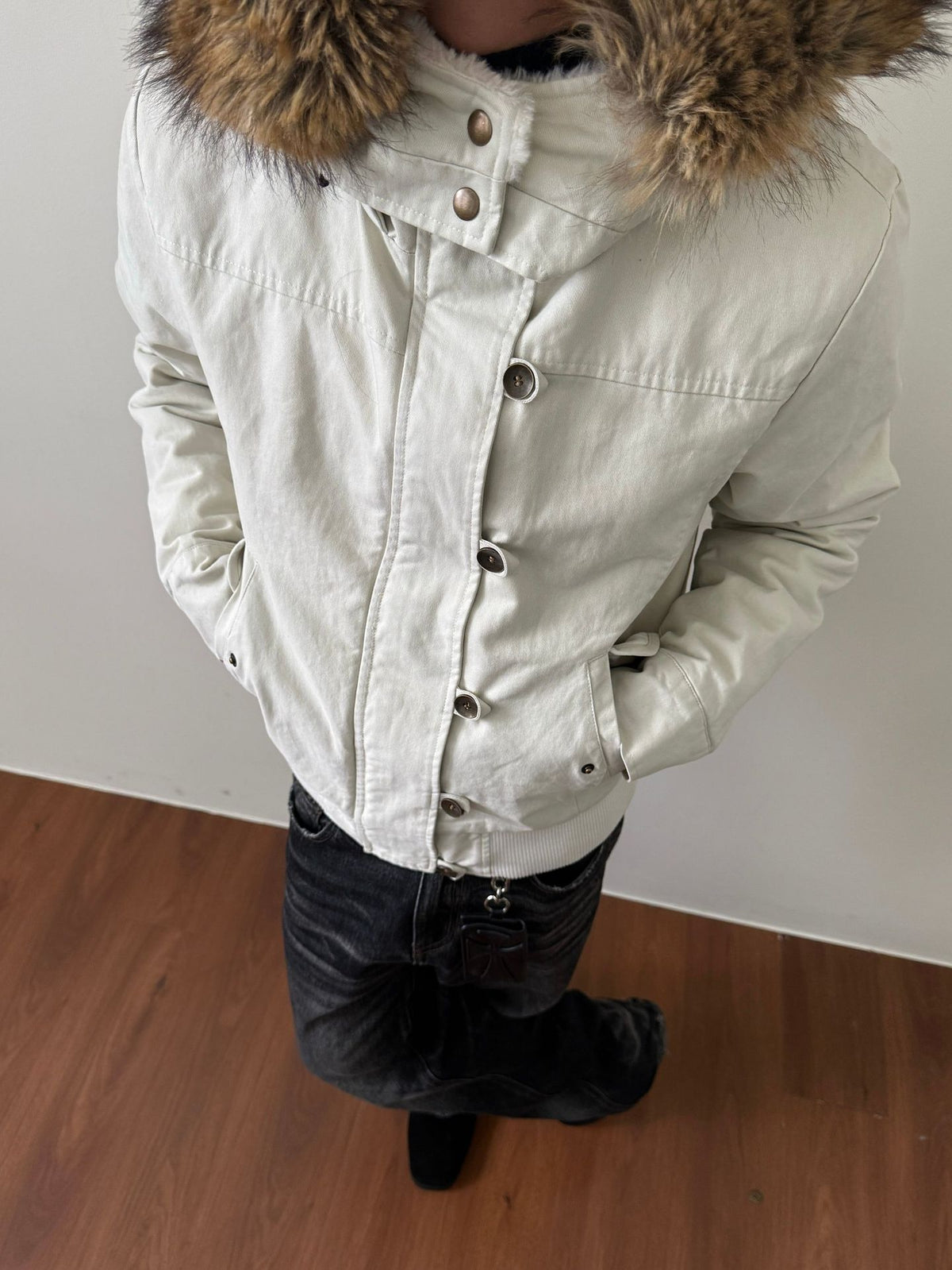 Off white hooded jacket with fur trimmed hood and metal snaps, option photo for size M, worn with dark jeans