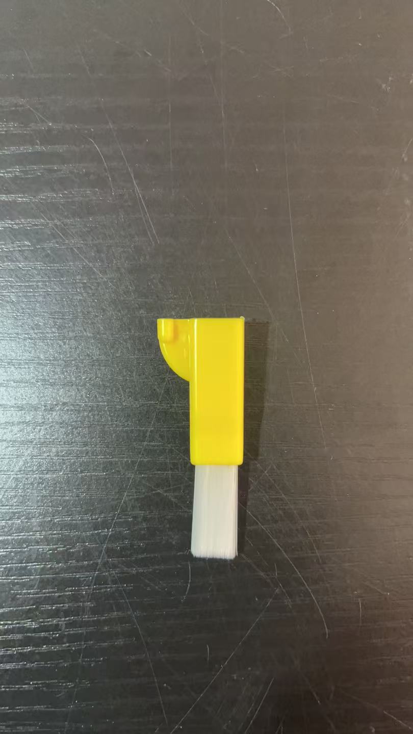 Single small yellow brush with white bristles on a dark surface, Yellow Small Brush option
