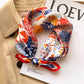 Red and blue abstract floral printed square scarf with a satin sheen and hemmed edges, shown displayed