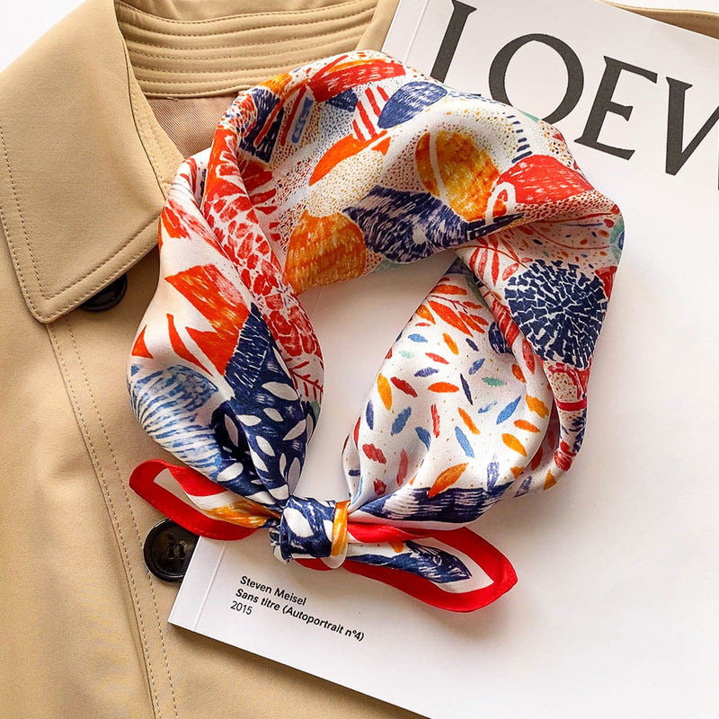 Red and blue abstract floral printed square scarf with a satin sheen and hemmed edges, shown displayed