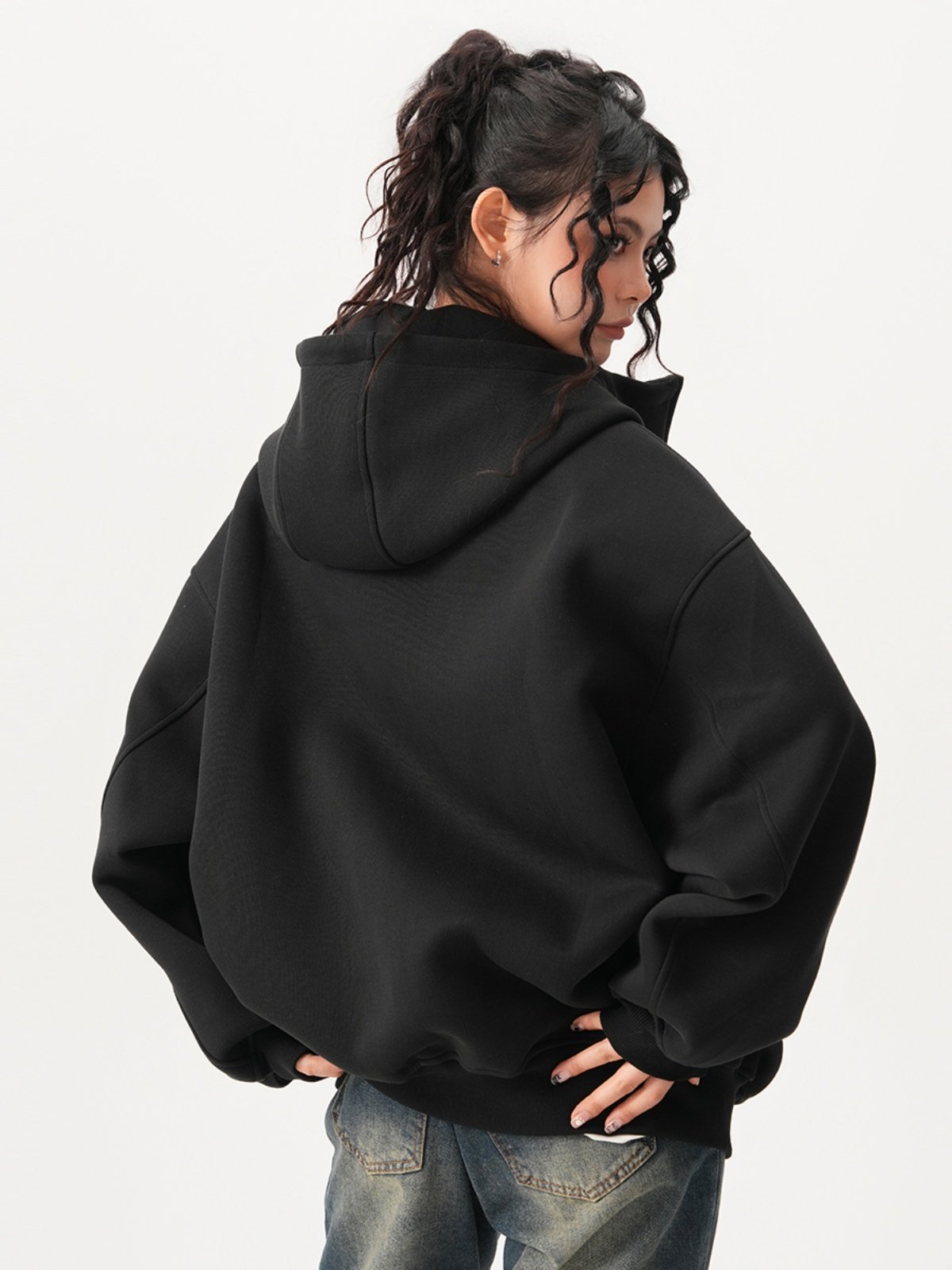 Back view of the oversized hooded sweatshirt showing the deep hood and ribbed hem