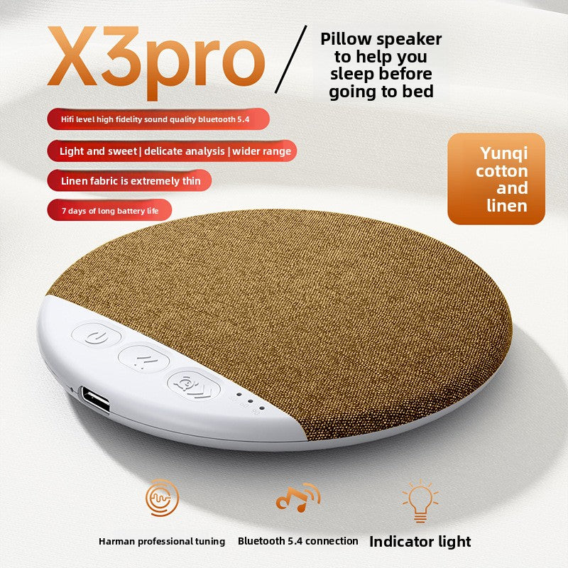 Tan brown pillow speaker on white fabric with the button row in view