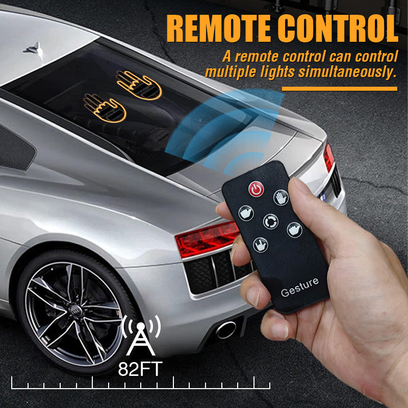 Remote control held beside a silver car with two lit hand lights on its rear window, range marked 82FT