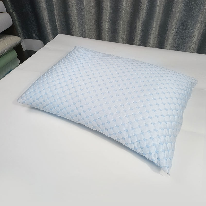 Rectangular memory foam bed pillow with a quilted cooling knit cover resting on white sheets