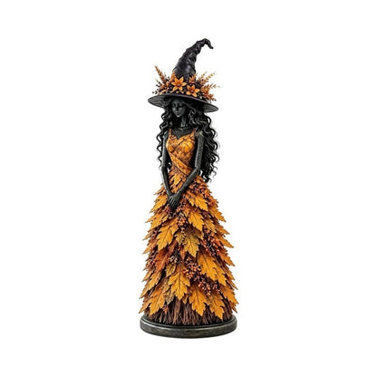 Autumn witch resin statue with orange leaf gown and flower-trimmed black hat on a white background