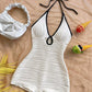 Halter neck bodycon romper in white rippled stretch fabric with a self tie bow and keyhole cutout