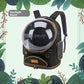 Black space capsule cat carrier backpack with clear dome, side mesh panel and front zip pocket on a leaf background