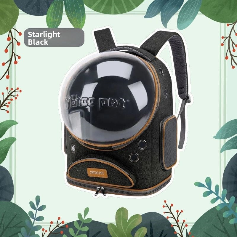 Black space capsule cat carrier backpack with clear dome, side mesh panel and front zip pocket on a leaf background