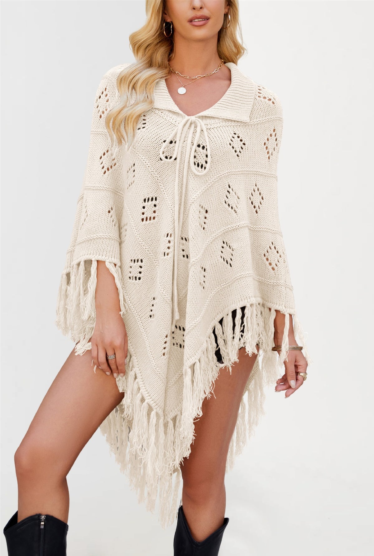 Openwork diamond eyelet knit poncho with a folded collar and long knotted tassel fringe