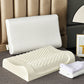 White covered contour pillow beside a cream latex core with a raised nub massage surface