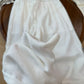 Yellow cotton linen straight-leg pants with elastic waist on a wooden tray