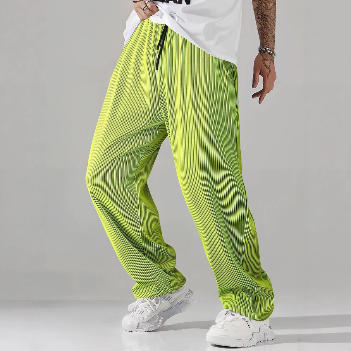 Mens drawstring pleated casual pants shown mid stride to show the fabric drape