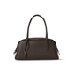 Leather shoulder handbag styled in a modern interior scene