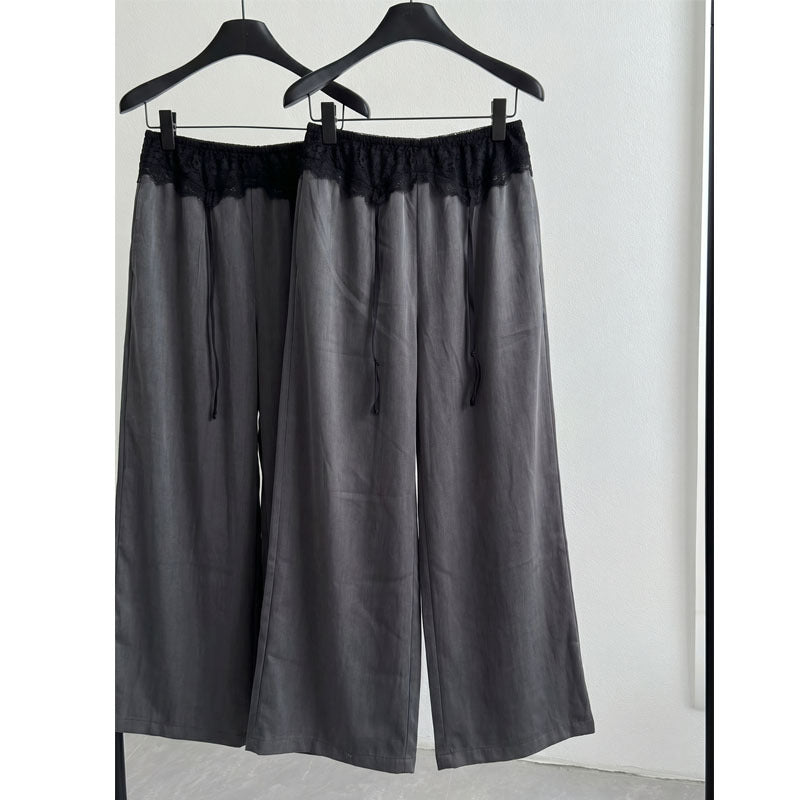 Two gray wide-leg pants on black hangers showing lace waist and drape