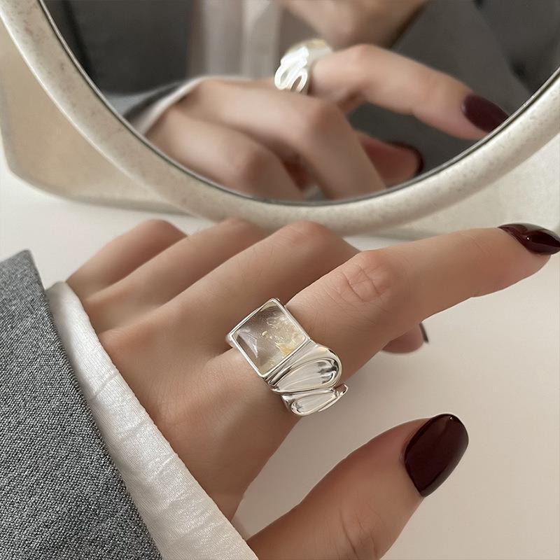 Close up of the silver-tone ring band texture and geometric front detail