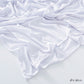 White modal cotton headscarf wrap draped in loose folds showing the light jersey knit and rolled edge