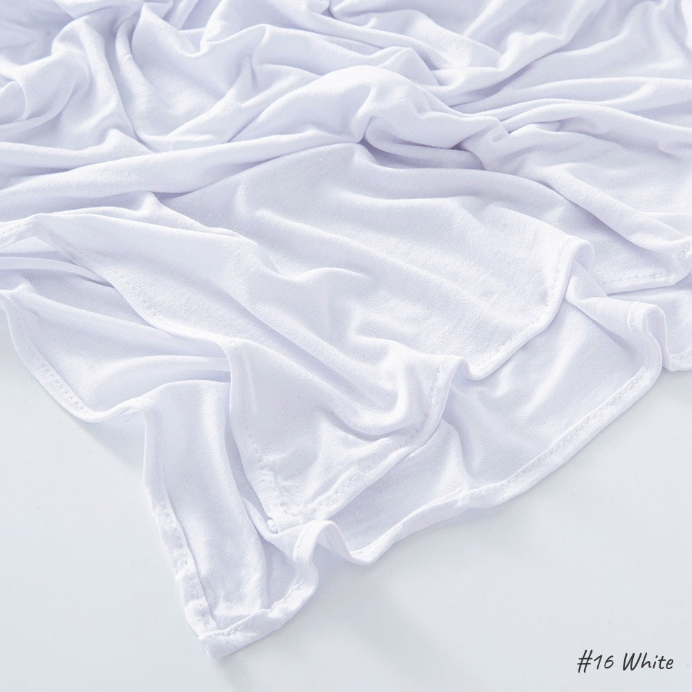 White modal cotton headscarf wrap draped in loose folds showing the light jersey knit and rolled edge