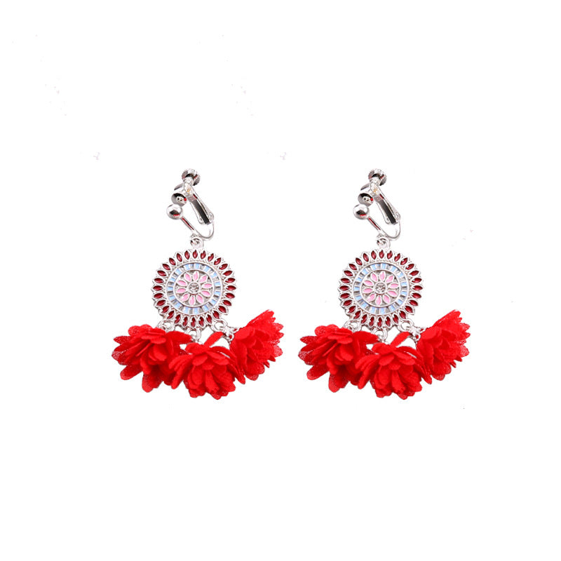 Handmade bohemian clip-on earrings with tassel and bead drop detail, zinc alloy frame, studio shot on white background