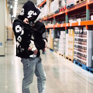 Side view of the grey cotton wreath print hoodie showing the drawstring hood and long sleeve