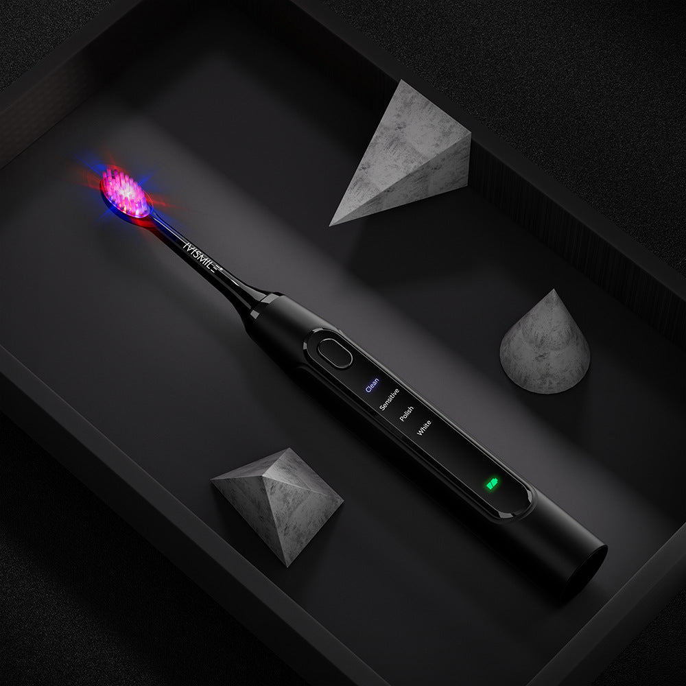 Black IVISMILE electric toothbrush with a pink glow from the LED brush head on a dark background