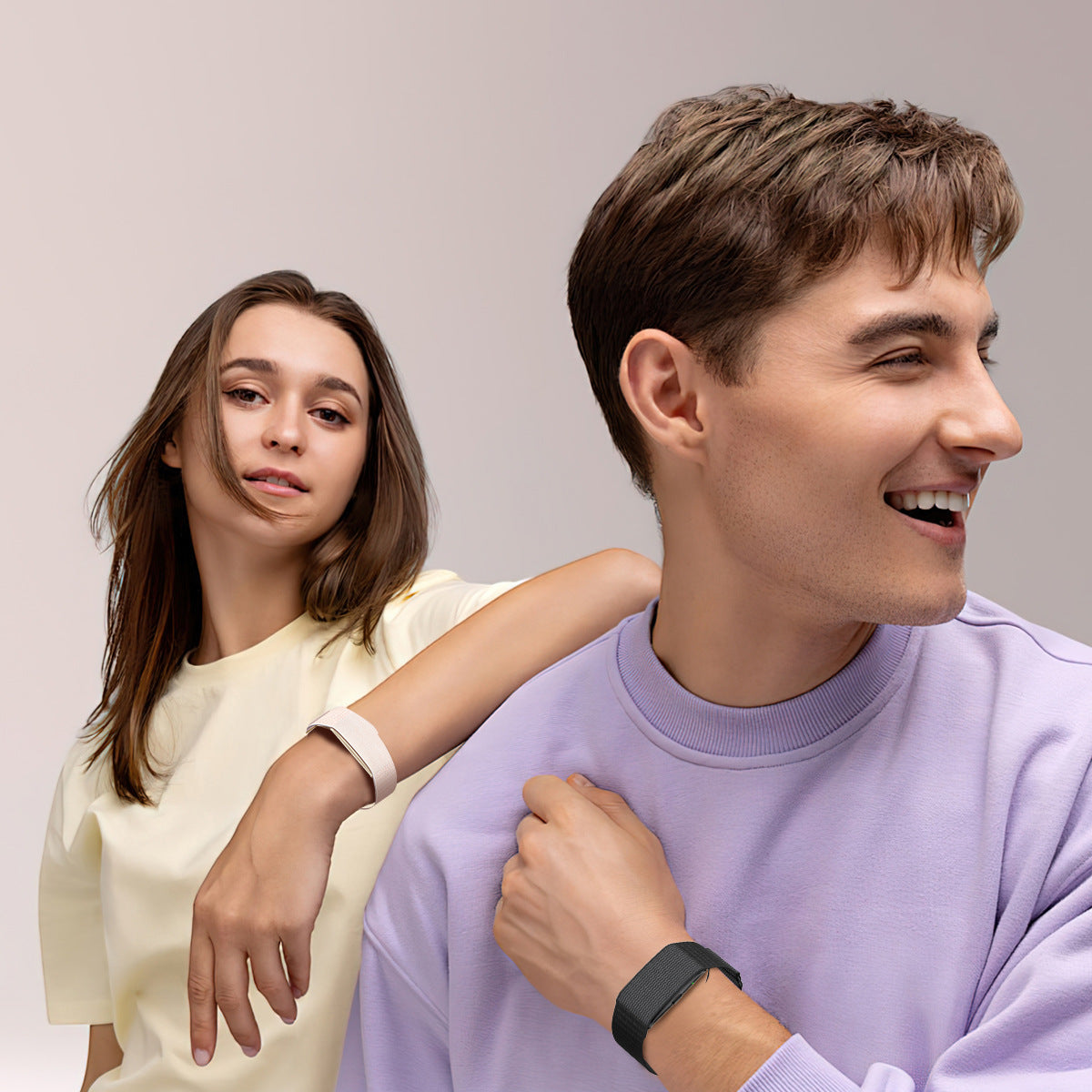 Two people wearing the screenless smart bracelet, one on a black band and one on a light band