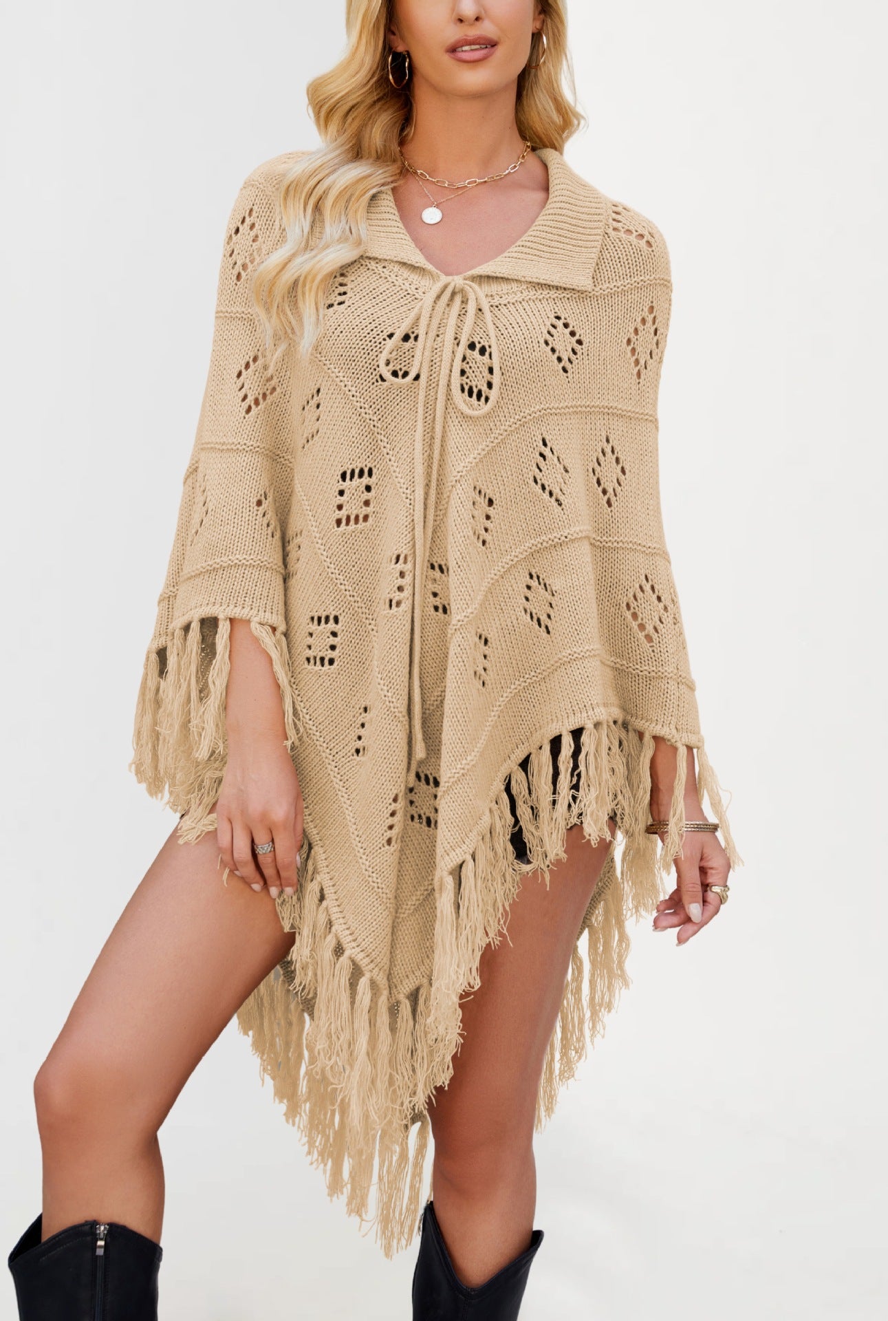 Openwork diamond eyelet knit poncho with a folded collar and long knotted tassel fringe