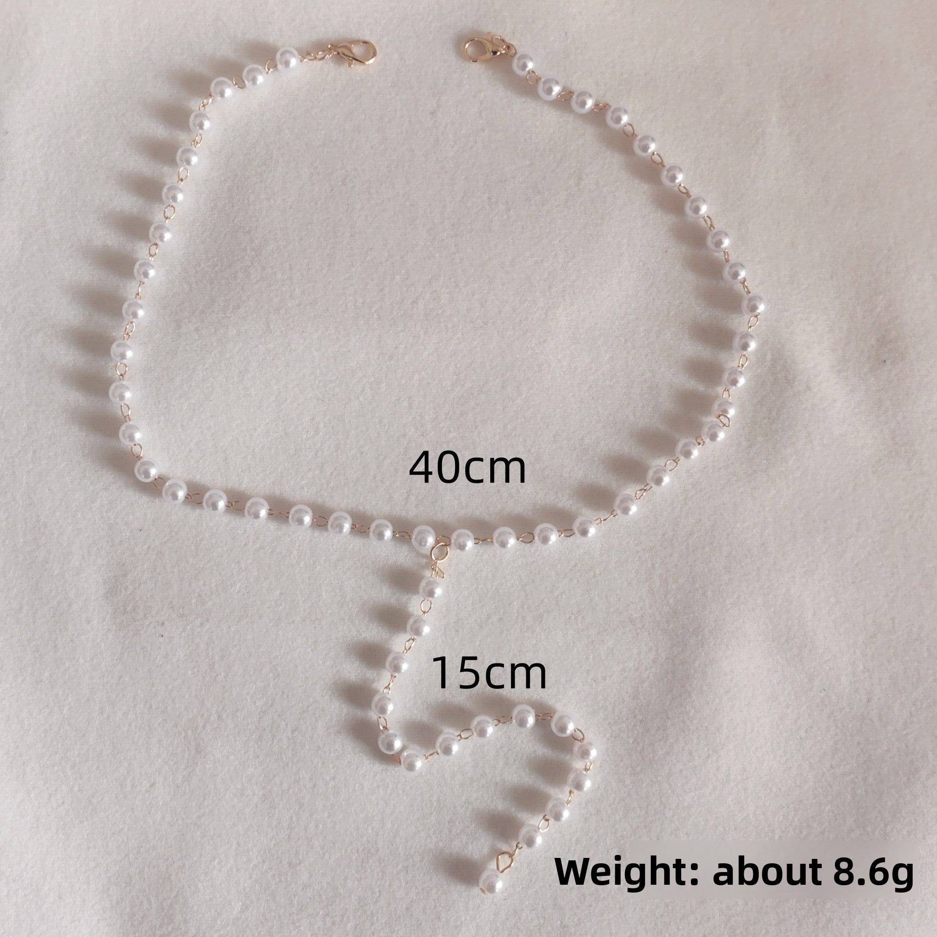 Full length view of the layered Y drop back necklace in gold tone