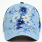Curved brim adjustable cap covered with a printed garden flower design