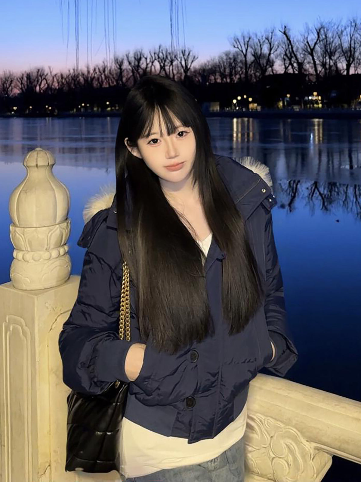 Navy Blue variant, size XL: navy quilted hooded jacket worn by a model at a lake at dusk, hands in pockets
