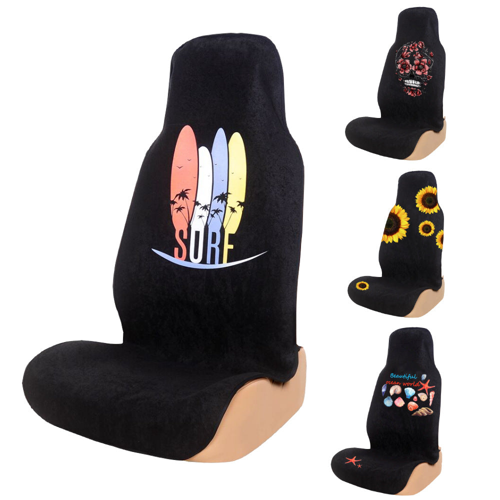 Black terry cloth car seat cover with a printed surf design beside three other prints, designs not among the options