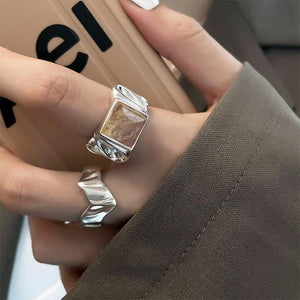 Side profile of the open silver ring showing the split ends of the band