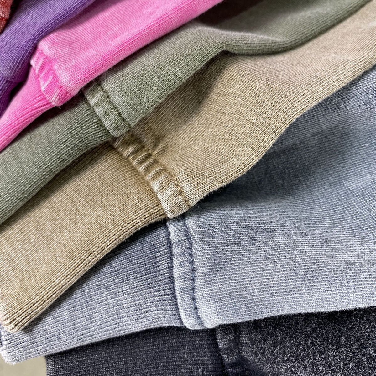 Raw frayed hem and cuff detail on the dark blue heavyweight washed tee