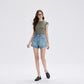 Woman walking in retro blue high waist denim shorts with wide short legs