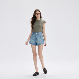 Woman walking in retro blue high waist denim shorts with wide short legs