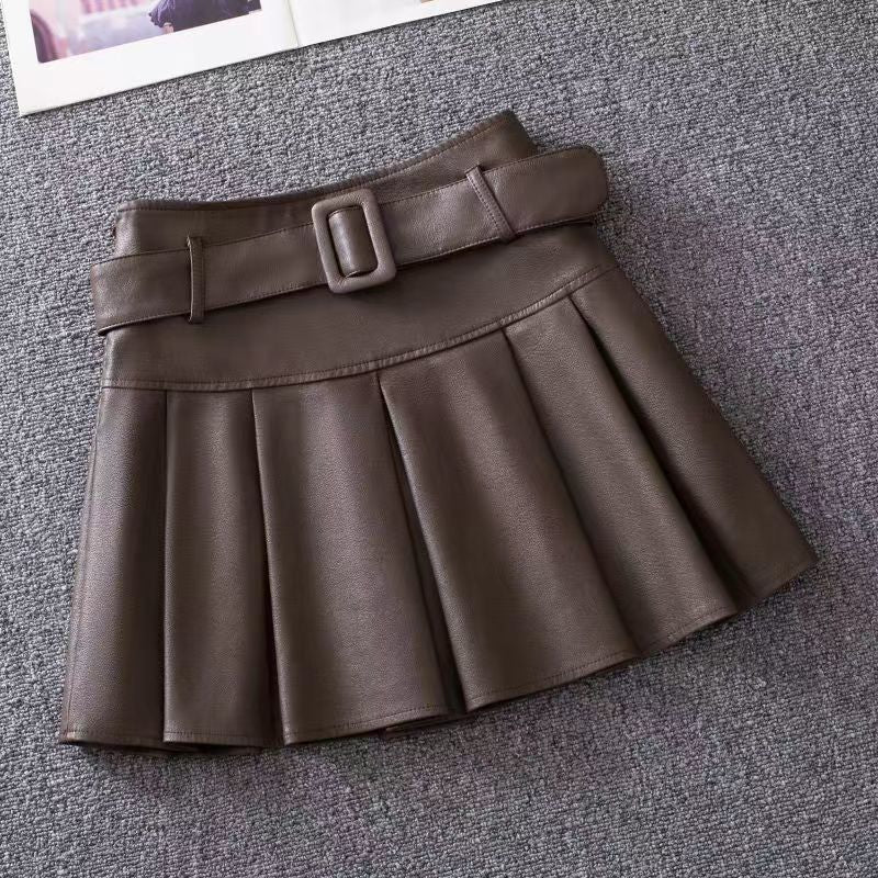 Coffee with Belt variant, size M: coffee pleated mini skirt with a self-fabric belt laid flat on gray carpet