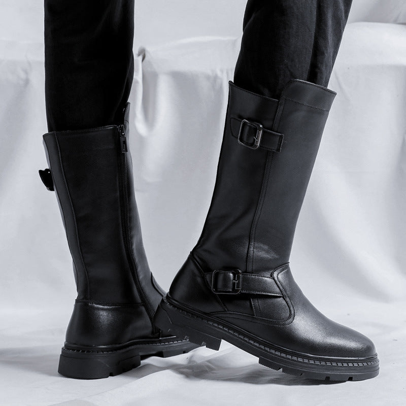 Two tall black buckle boots seen from the side, one showing the zipper, with lugged rubber soles