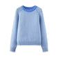 Blue striped knit women's sweater in soft studio lighting showing yarn texture