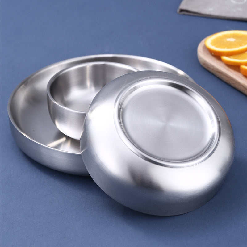 Double wall stainless steel bowl held to show the raised insulated base