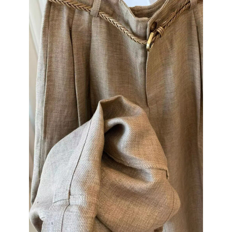 Close-up of khaki pants waistband braided belt and gold-tone ring buckle