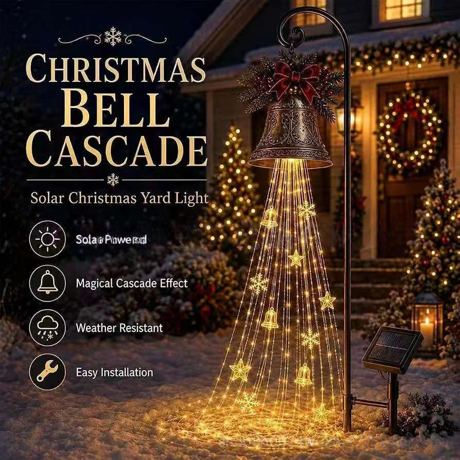 Bronze Christmas bell with red bow and evergreen sprigs lit with cascading warm strands in front of a decorated porch