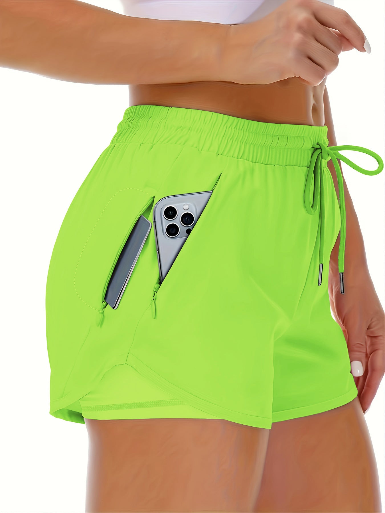 A red womens running shorts shown from the side with the tulip hem and inner liner