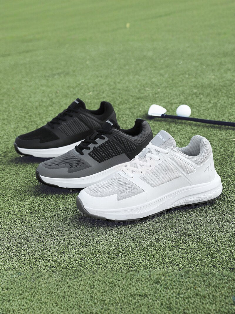 Close view of a mens golf shoe outsole showing the replaceable metal spikes
