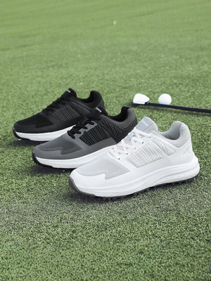 Close view of a mens golf shoe outsole showing the replaceable metal spikes