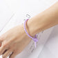 Tadpole silicone tie looped around a wrist to show how flexible the strap is