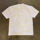 Plain white back of the oversized heavyweight cotton tee laid flat on the floor