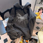 Washed black oversize hoodie shown on a chair