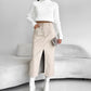 Khaki size S option: beige PU leather midi skirt with a front slit worn with a white sweater and white boots